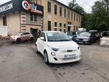 a small white car parked in front of a building