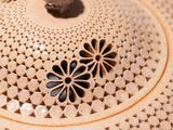 a close up of a brown pot on a white surface