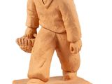 figurine of a baseball player holding a glove and a ball