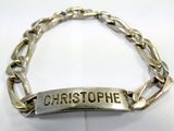 silver plated bracelet with name engraved on it on a white surface
