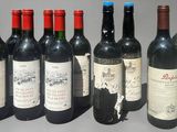 six bottles of red wine are lined up in a row