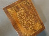 a small wooden box with a decorative design on it