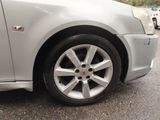 a silver car that is parked in a parking lot