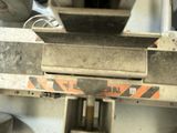 a close up of a machine that is working on a piece of metal