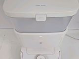 a white and gray machine sitting on a white surface