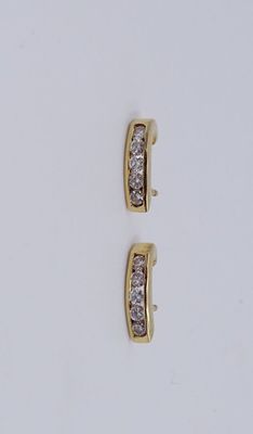a pair of diamond earrings on a white surface