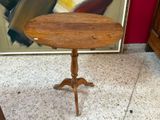 a small wooden table with a wooden top on a marble floor
