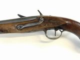 an old gun with a wooden handle on a white background