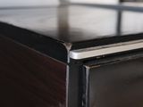 a close up view of a wooden table with a metal top