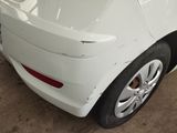 the rear end of a white car in a garage