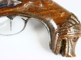 a gun that is sitting on a white surface