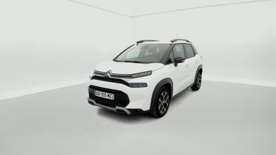 a white car is parked in a white room with a white floor