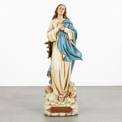 the statue of the virgin mary is holding a baby jesus in her arms