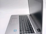 a silver laptop with a blue sticker on the screen
