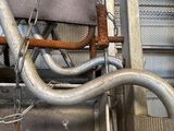 a metal pipe that is connected to a metal structure