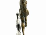 a bronze statue of a woman and a dog on a wooden base