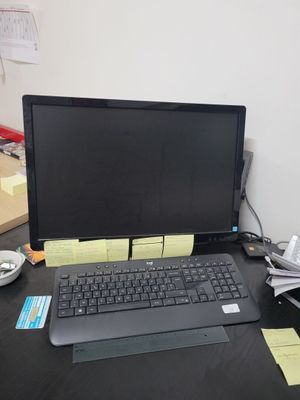 a laptop computer sitting on a desk next to a keyboard