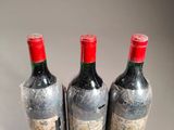 three bottles of wine sitting next to each other on a table
