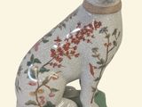 a figurine of a dog sitting on top of a box