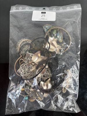 a bag full of assorted jewelry on a table