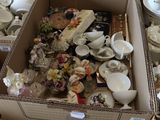 two boxes full of different types of china on the floor