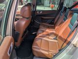 the interior of a car with brown leather seats and tan leather seats