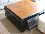 a coffee table that is sitting on a rug in a living room