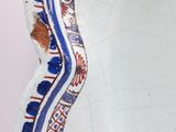 a blue and white plate with a design on it