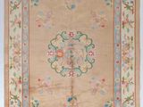 un tapis chinois ancien orné d'un motif floral sur fond beige