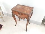 a small wooden table with a drawer on top of it