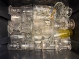 a pile of empty wine glasses in an open microwave