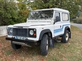 a picture of a white land rover parked on the side of the road
