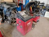 two machines that are sitting in a garage