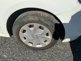 a white car that has a flat tire on it