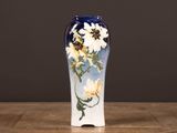un vase bleu orné de fleurs blanches, posé sur une table