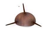 a clock that is made of metal and has a wooden base