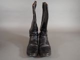 pair of black leather boots with zippers on them on a white surface