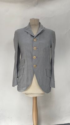 grey jacket on a mannequin stand with a white background