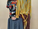 two shirts and a skirt on display in a store