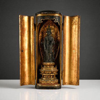 a gold and black statue of a woman in a doorway