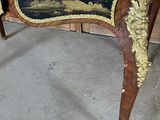 a wooden table with a black and gold design on it