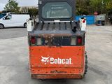 a picture of a bobcat forklift parked in a parking lot
