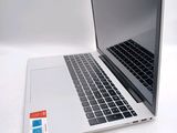 a laptop computer sitting on top of a white table