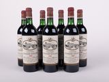 quatre bouteilles de vin sont alignées sur une surface blanche