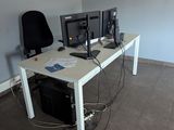 a desk with two computer monitors on it in a room