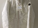an image of a white jacket hanging on a wall