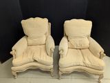 pair of antique french style lounge chairs with upholstered cushions