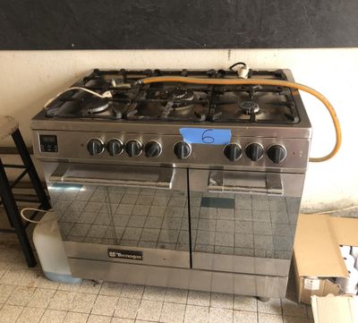 a stove that is sitting in the middle of a kitchen