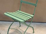two green chairs sitting next to each other on the floor