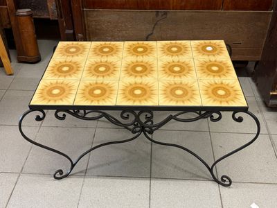a small table with a yellow and white tile on it